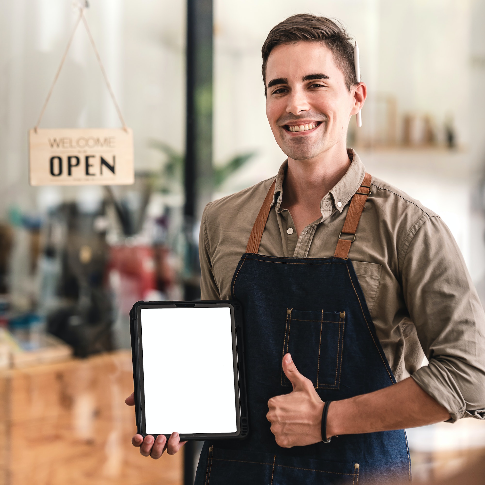 The coffee shop is open and male baristas are happy to serve you.